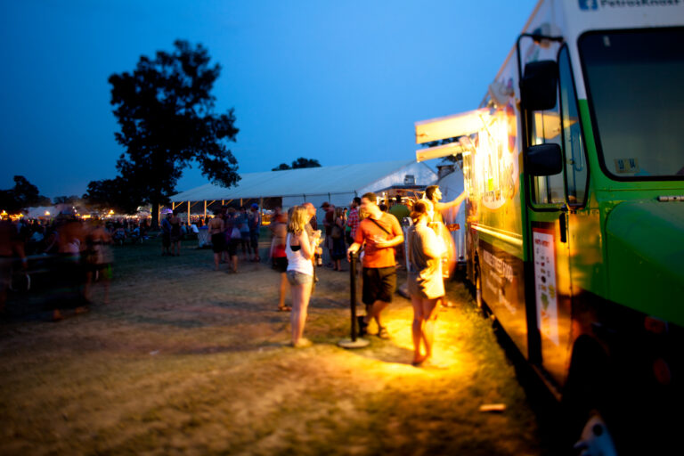 Festival goers getting dinner from a food truck
