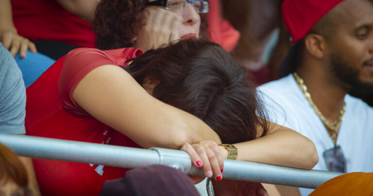 Sad female fan sitting in stadium